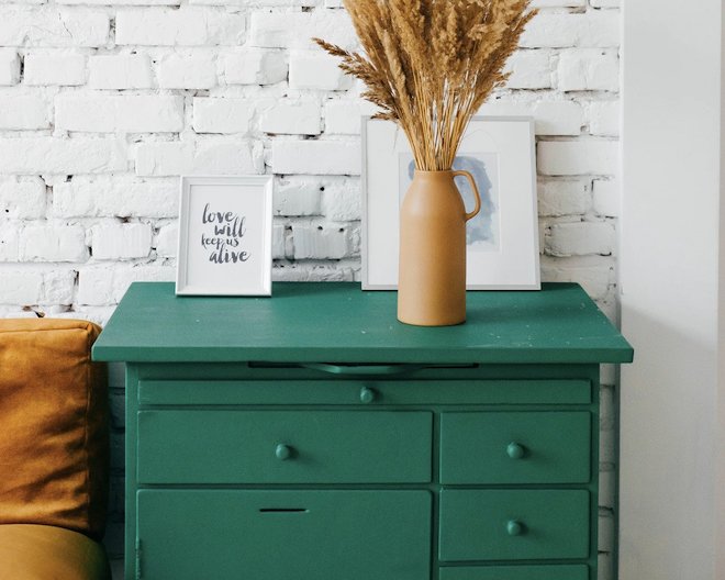 Green furniture with small decorations above